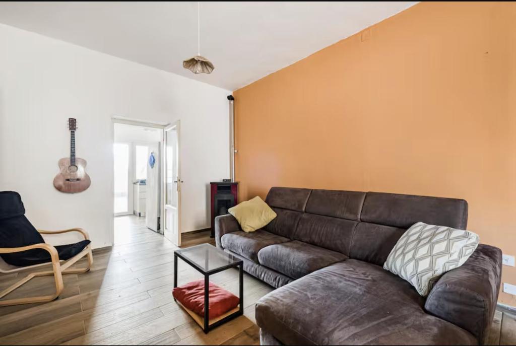 a living room with a couch and a chair at Da Marilena in Sorso