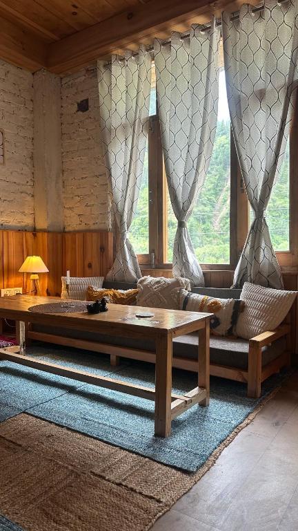 a living room with a couch and a table at Aroha Living in Bandal