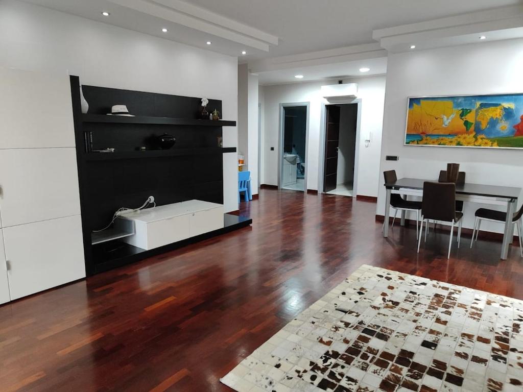a living room with a wooden floor and a table at Dimora C&A in Mondragone
