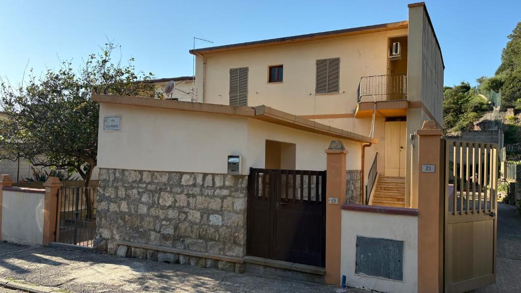 a house with a gate and a fence at La casa di nonna Gianna in Gonnesa