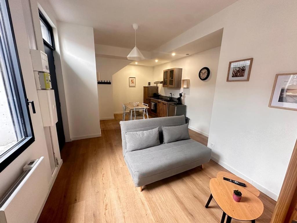 a living room with a couch and a table at Aquero Lourdes T2 in Lourdes