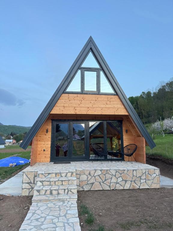 a cabin with a pitched roof with windows at Forest View Kolašin in Kolašin
