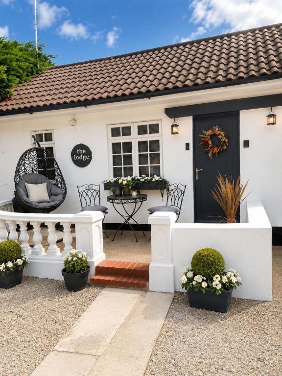 a white house with a wreath on the door at The lodge in Rushbrooke