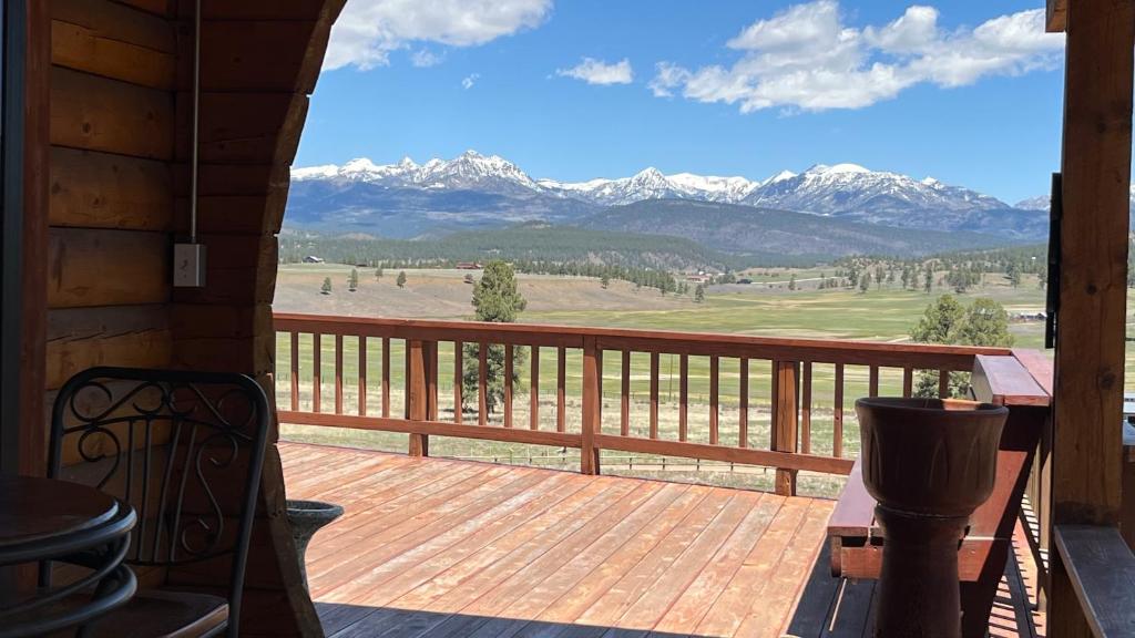 a porch with a view of snow covered mountains at Elkwood Manor Bed & Breakfast in Pagosa Springs
