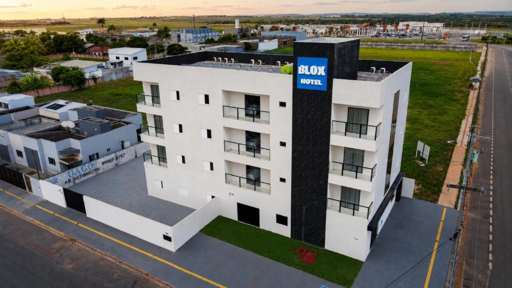 an aerial view of a building with a sap sign on it at Hotel Blox Sorriso in Sorriso