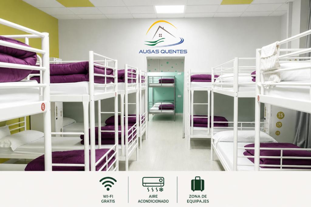 a room with white bunk beds with purple sheets at Augas Quentes Hostel in Ourense