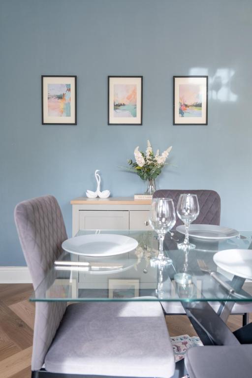 a dining room with a glass table and chairs at 2 BR Apartment- Private Parking in Newport