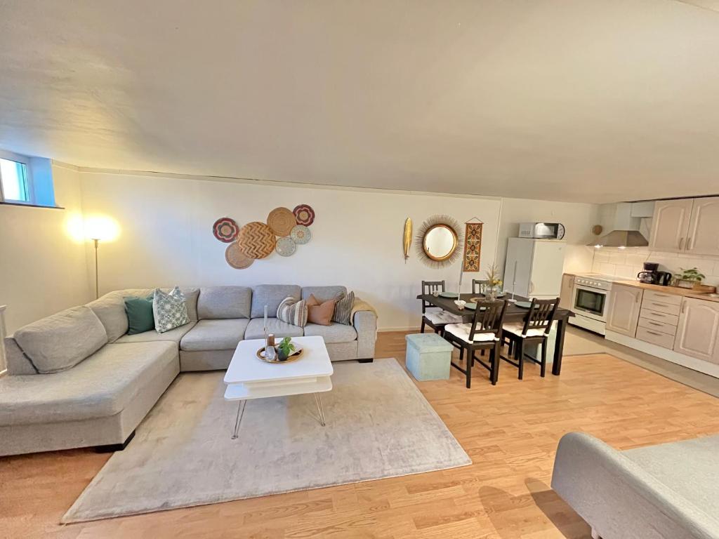a living room with a couch and a table at Joselia in Falkenberg