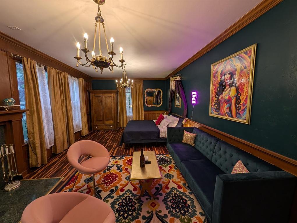 a living room with a couch and a table at The Queen Hotel- Downtown Luxury in Sturgeon Bay