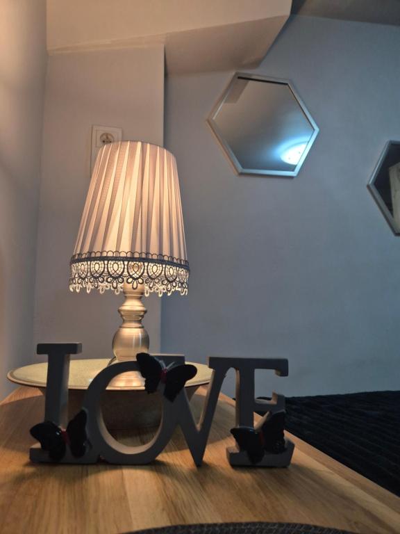 a lamp sitting on top of a table in a room at Radiowa mini in Warsaw