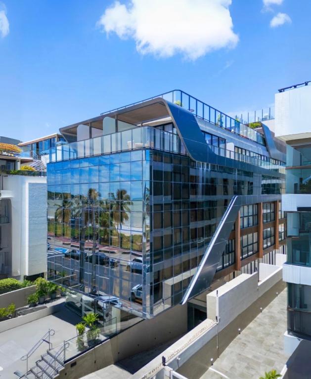 an office building with a glass facade at Cabo Branco Flat Amsterdam in João Pessoa