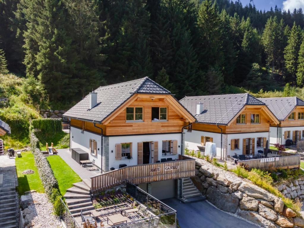 an aerial view of a house with a stone wall at Haus Ganbei in Donnersbachwald