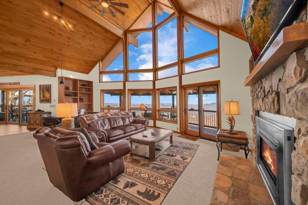 a living room with a couch and a fireplace at Soaring Eagles View in Beech Mountain