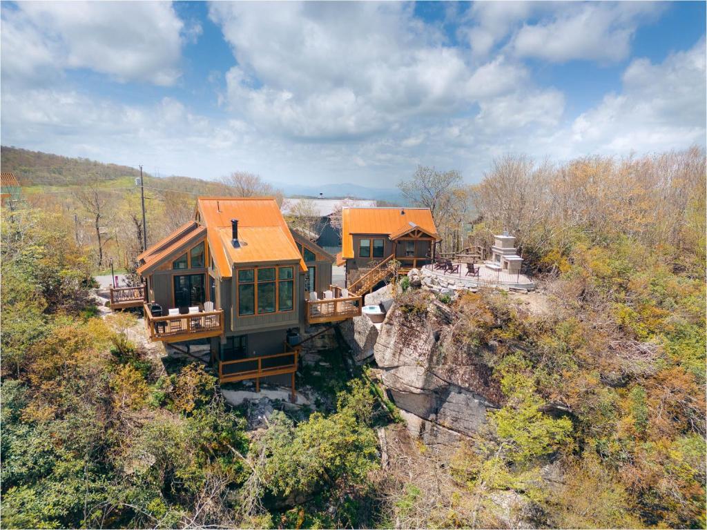 an aerial view of a house on a cliff at On The Rocks Straight Up in Beech Mountain