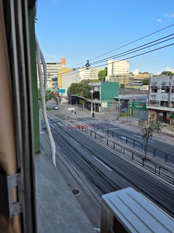 a view of a city street from a train window at Hospedaria Vitoria in Vitória