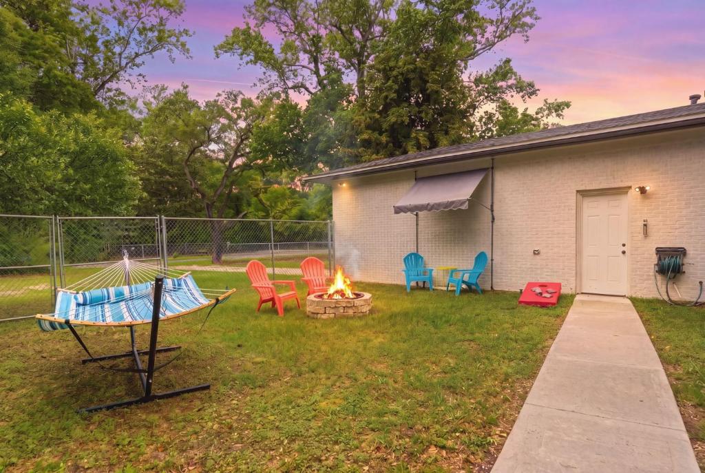 a backyard with chairs and a fire pit at Escape by Beaches & Blue Angels in Pensacola