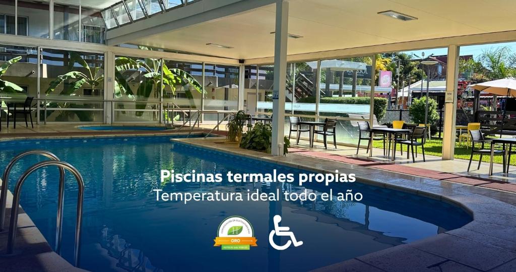 a resort with a swimming pool and a restaurant at Aguasol Hotel Termal in Termas del Daymán