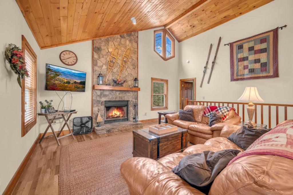 a living room with a couch and a fireplace at Appalachian Breeze in Blowing Rock