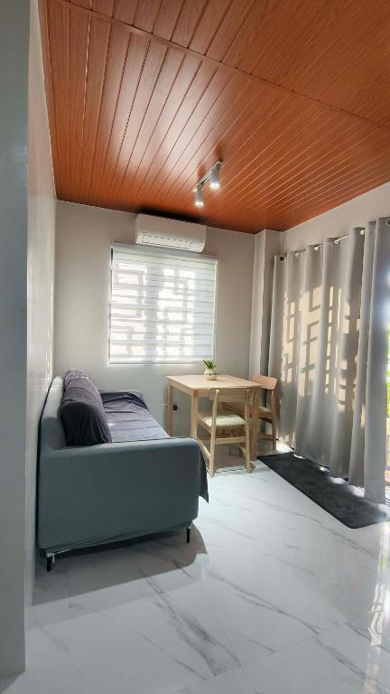 a living room with a couch and a table at Engil's Studio in San Jose Dinagat Islands Philippines in Bulawan