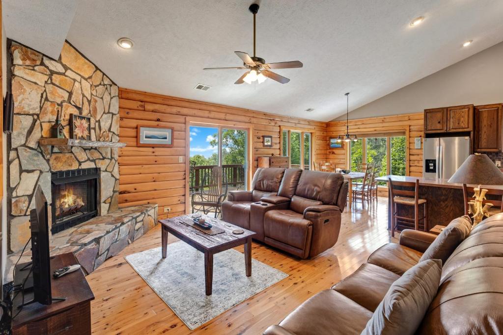 a living room with a couch and a fireplace at Blue Mist in Blowing Rock