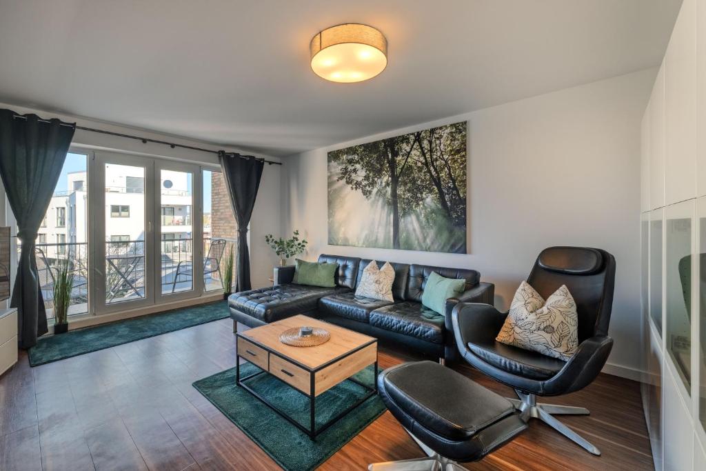 a living room with a couch and a table at Marina Hafenblick 321 in Cuxhaven