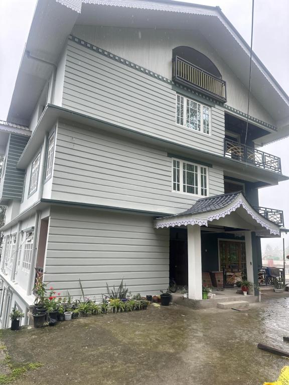 a large white building with a balcony at The Golden Attic in Yangang