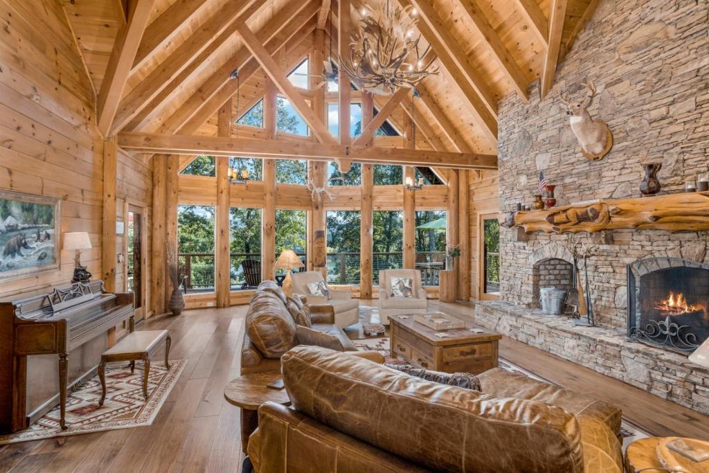an open living room with a stone fireplace at Lake Haven Lodge in Wilkesboro
