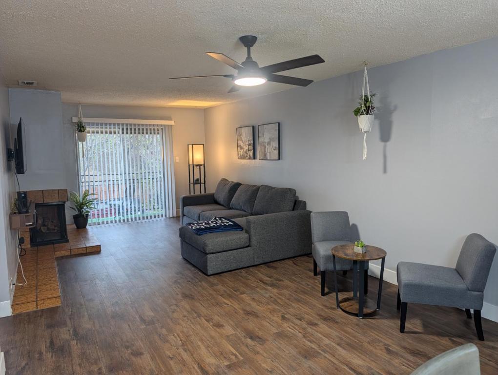 a living room with a couch and a ceiling fan at Entire One Bedroom Condo with AC, Wifi, & Pool in San Antonio