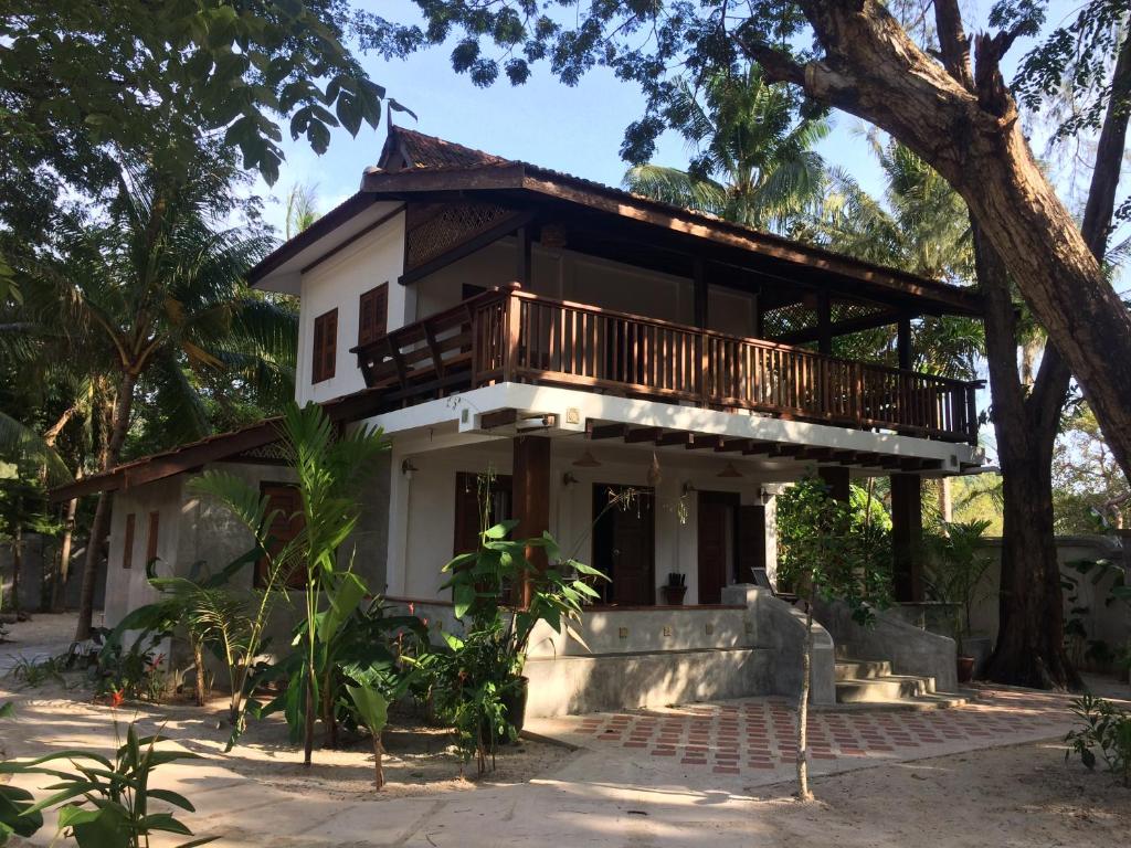 a house with a balcony on top of it at Rumah Jah Langkawi in Pantai Cenang
