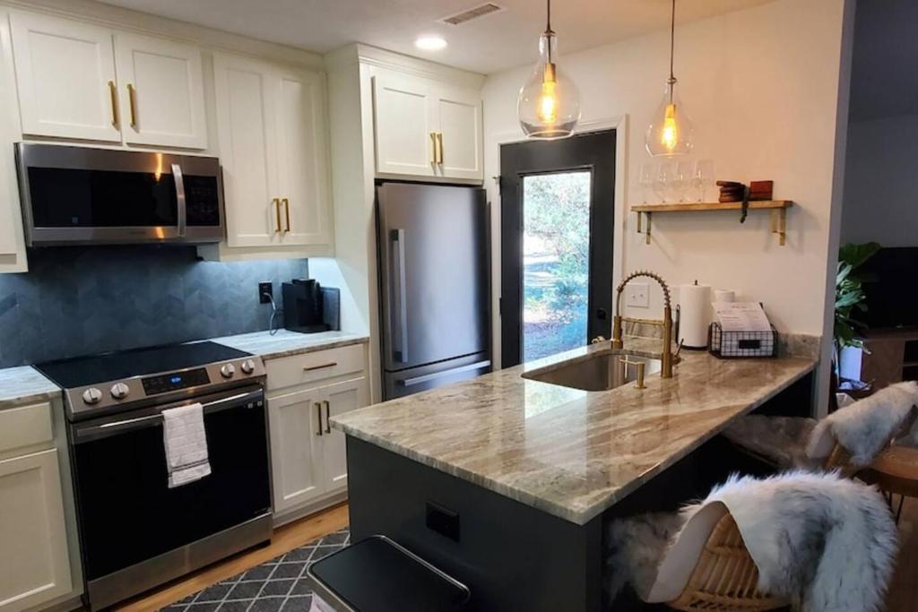 a kitchen with a sink and a refrigerator at On Golf Course Peaceful Central Upscale in Columbus