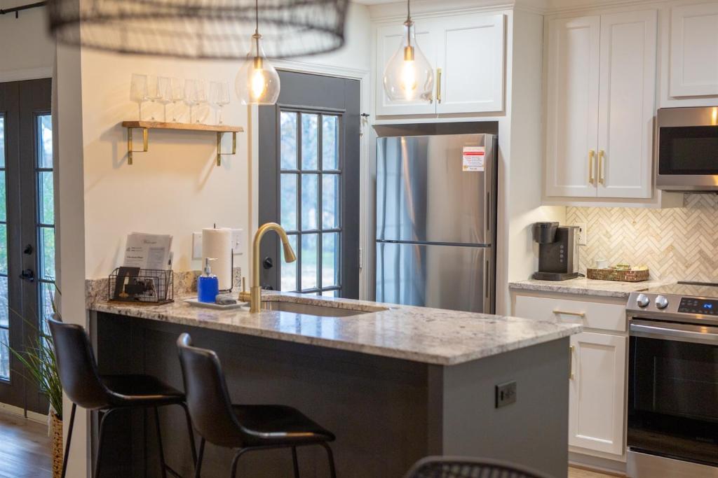 a kitchen with a sink and a refrigerator at Golf Course Views, Sunsets & Chill Vibes in Columbus