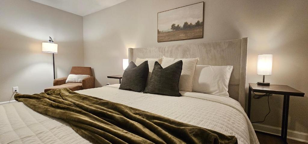 a bedroom with a large white bed with pillows at Golf-Side Retreat Calm Central Stylish in Columbus