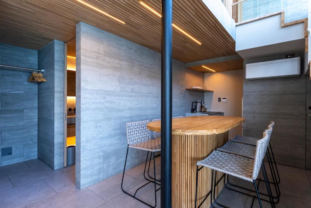 a kitchen with a wooden table and chairs at KONA OCEAN Club in Awaji