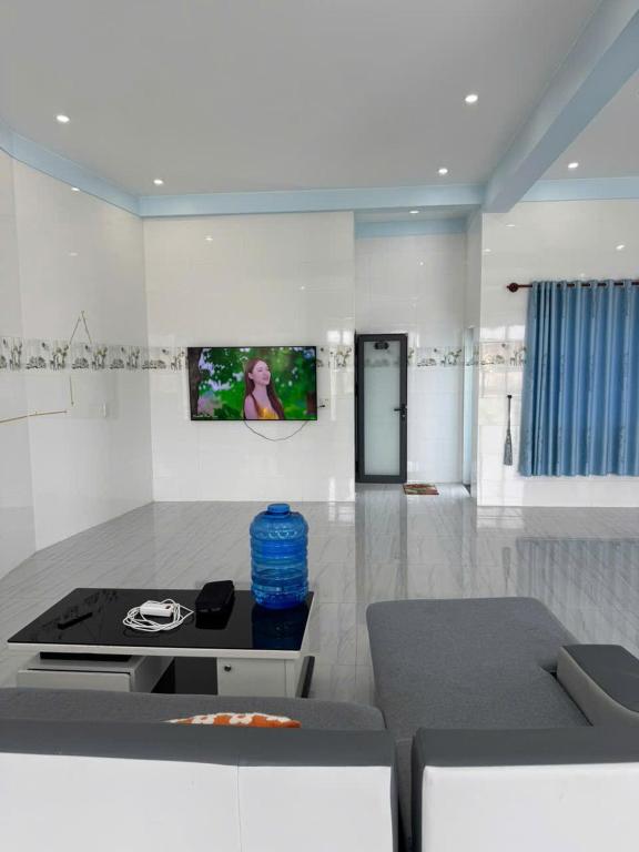 a living room with a couch and a table at KEN Homestay in Cu Lao Thu
