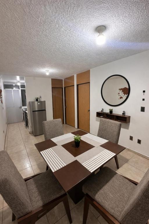 a dining room with a wooden table and chairs at Casa mezquite in Ocotlán