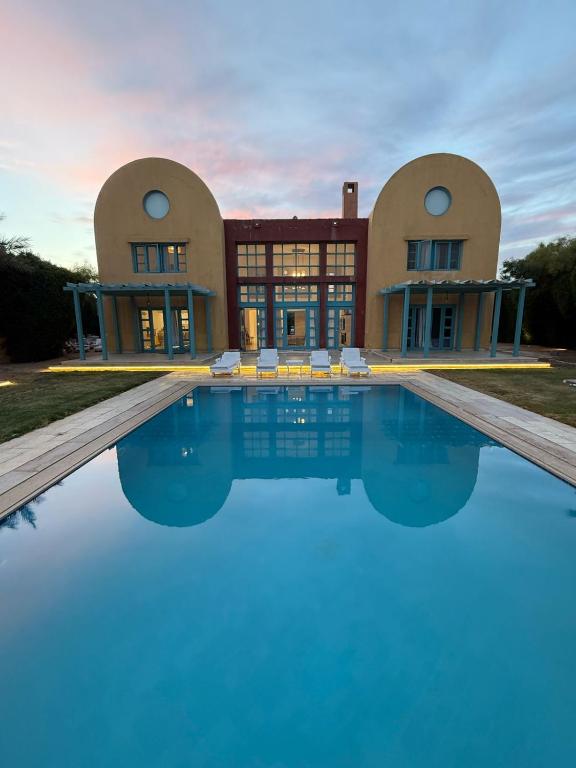 a house with a swimming pool in front of it at Golf El Gouna 2 in Hurghada
