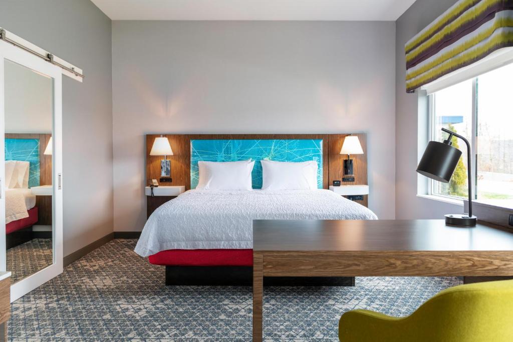 a hotel room with a bed and a desk at Hampton Inn & Suites Mattoon in Mattoon