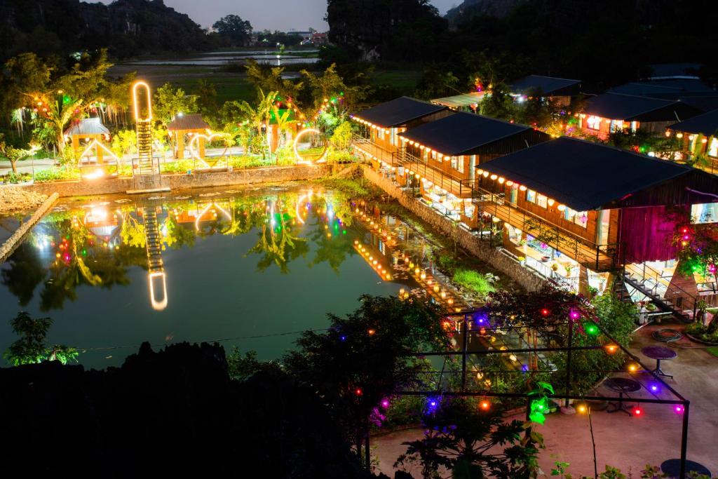 a view of a pool at night with christmas lights at Hang Mua Eco Park in Ninh Binh