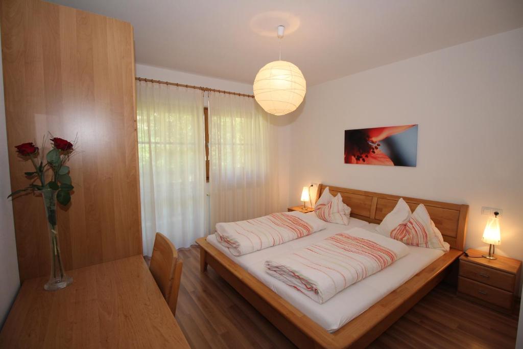 A bed or beds in a room at Apartments Im Winkl