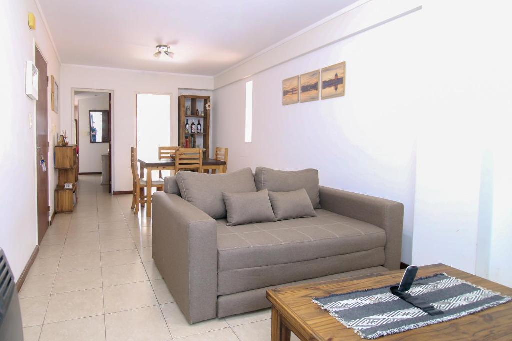 a living room with a couch and a table at Candioti I Apartment - Santa Fe in Santa Fe