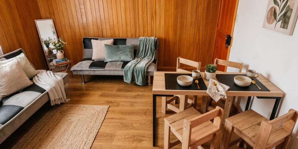a living room with a couch and a table at Cabañas JP puerto montt in Puerto Montt