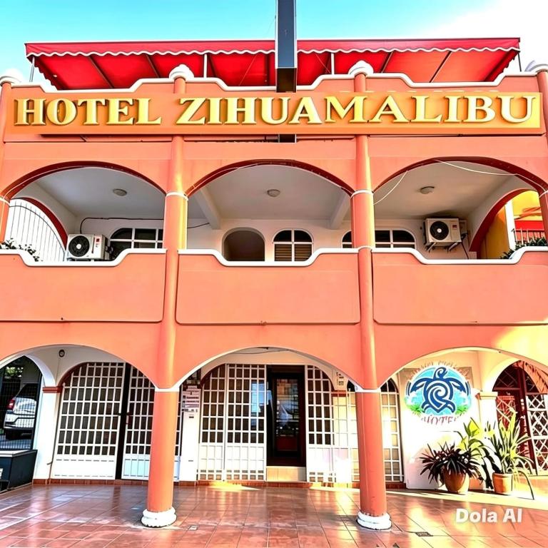 an orange hotel with a sign on the front of it at Hotel Zihua Malibu in Zihuatanejo