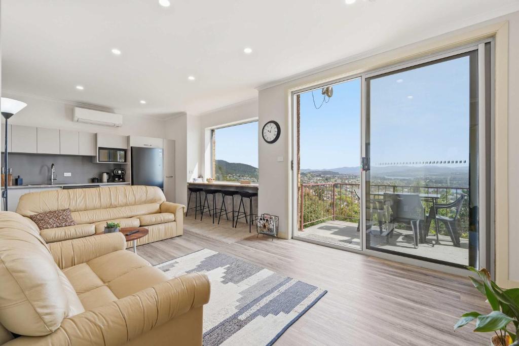 a living room with a couch and a large window at MONA Vista, Tasmania in Rosetta