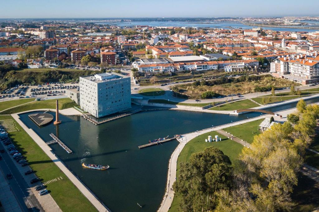 an aerial view of a city with a river and buildings at Meliá Ria Hotel & Spa in Aveiro