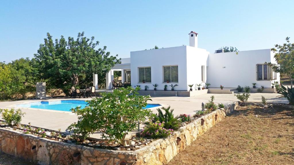 a house with a swimming pool in front of it at Eliofos Luxury Villa in Polis Chrysochous