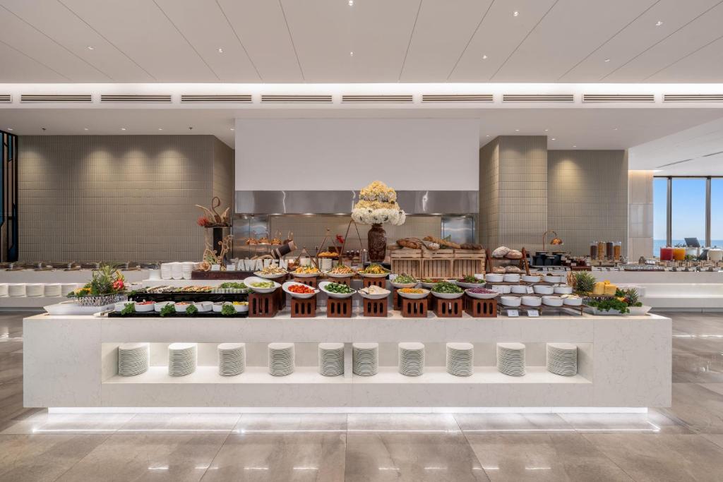 A large breakfast buffet with hot dishes, salads, bread and plated items.
