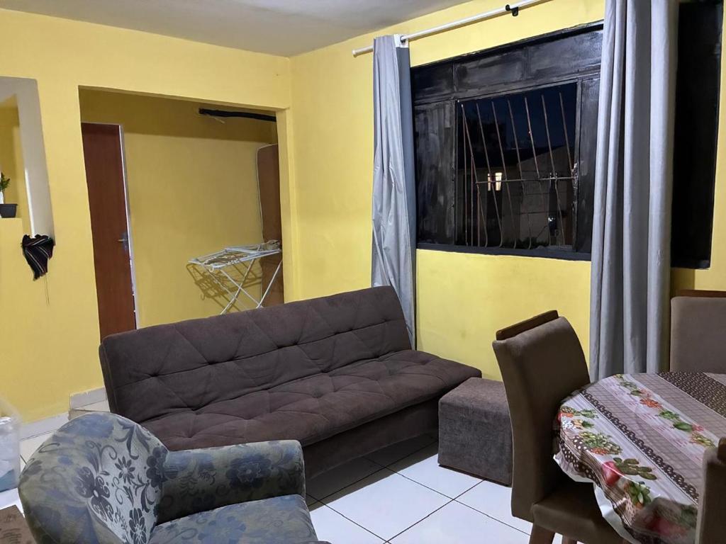 a living room with a couch and a window at Proximo ao Shopping e Aeroporto 2 Quartos com Ar e TV a Cabo in Várzea Grande