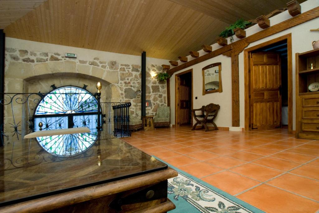 a room with a stone fireplace and a tile floor at Casa Del Palacio in Aguilafuente