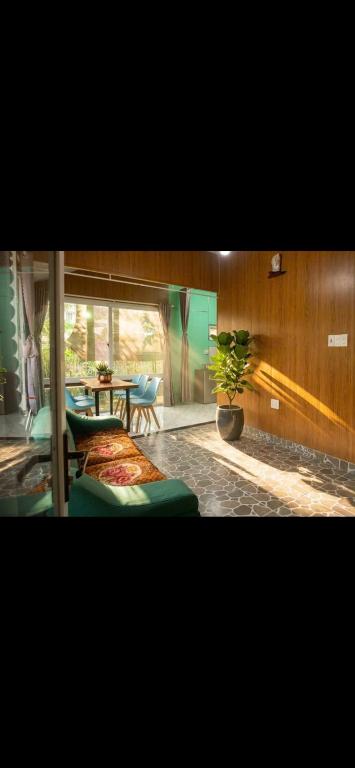 a room with two beds and a table with a plant at Valley homestay Dalat in Da Thien