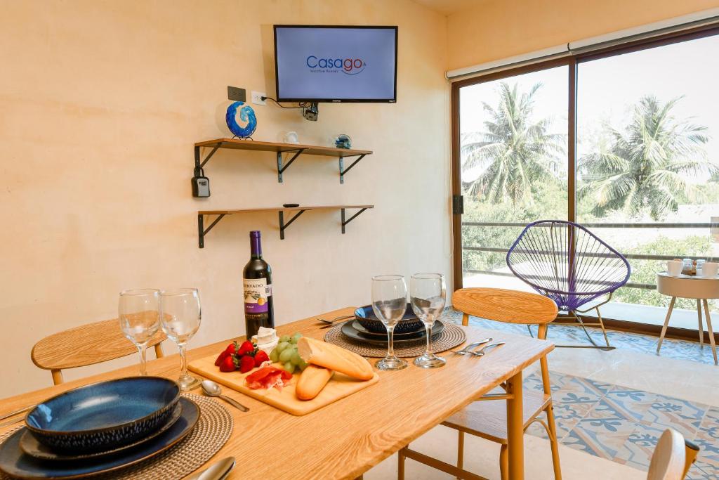 a dining room with a table with a plate of food at In Wotoch Chicxulub by Casago in Chicxulub